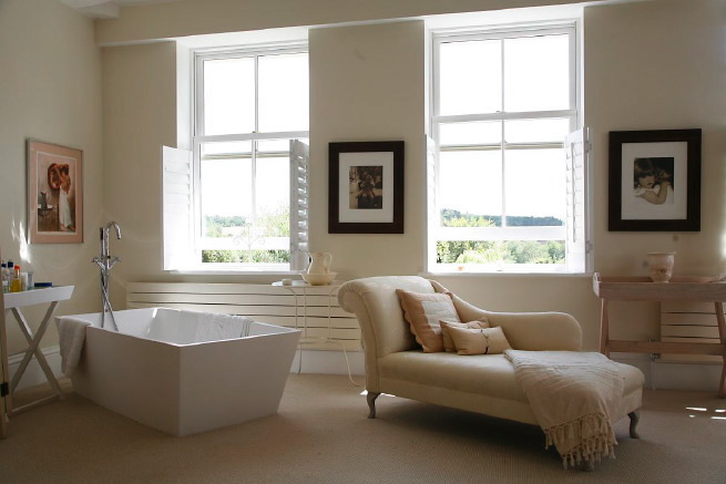 Great contemporary free-standing bath in a huge light bedroom with plantation shutters and a separate en-suite.