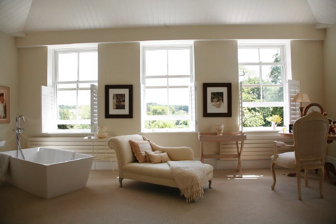 Great contemporary free-standing bath in a huge light bedroom with plantation shutters and a separate en-suite.