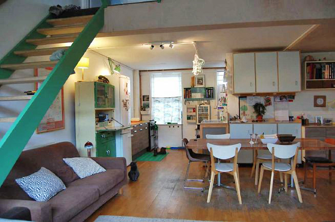 Modern terraced house built as a live/ work studio. Living space is split level with quirky details. Also features a roof terrace with views of the city/ East London.