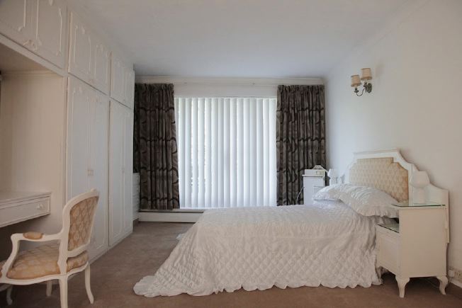 Stylised, neutral double bedroom at fantastic 70's house.
