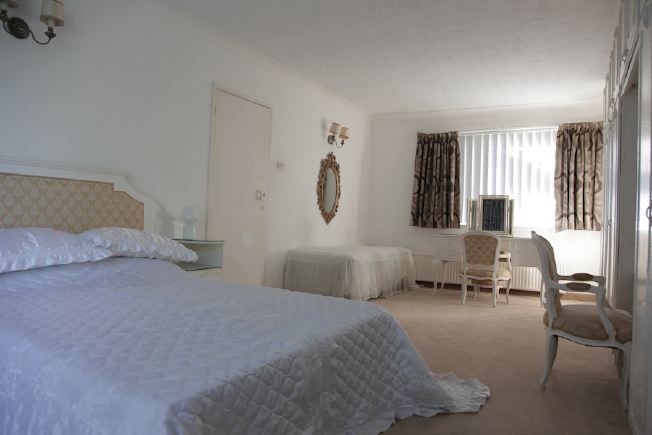 Stylised, neutral double bedroom at fantastic 70's house.
