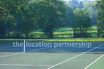Private tennis court in the grounds of a Grade I listed farmhouse.
