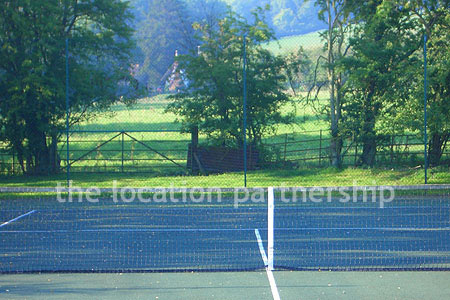 Private tennis court in the grounds of a Grade I listed farmhouse.