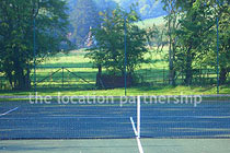 Private tennis court in the grounds of a Grade I listed farmhouse.