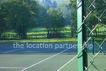 Private tennis court in the grounds of a Grade I listed farmhouse.