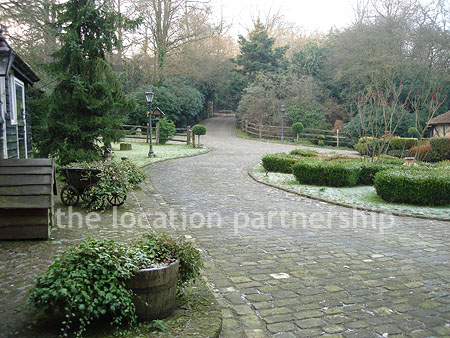 A large country house with 9 acre rural surroundings with private driveway, forecourt and tennis court.