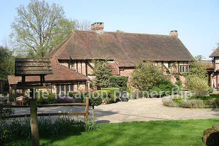 A large country house with 9 acre rural surroundings with private driveway, forecourt and tennis court.