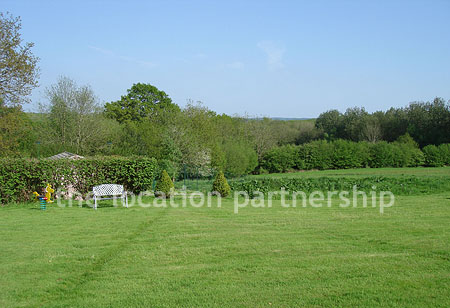 A large country house with 9 acre rural surroundings with private driveway, forecourt and tennis court.