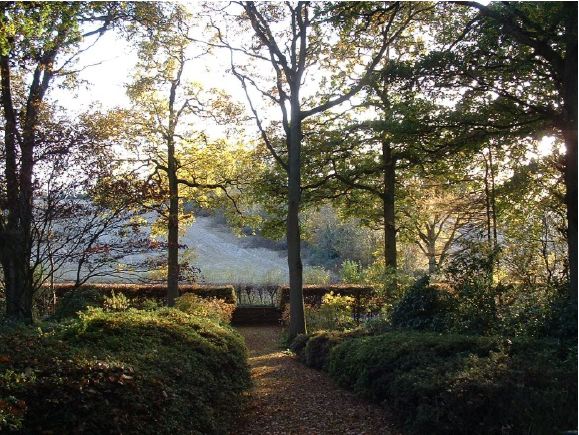 Twenty six acres of woodland garden with greenhouses, thatched folly, 2 ponds, sweeping lawns, large disused flint pit and many colourful plants.