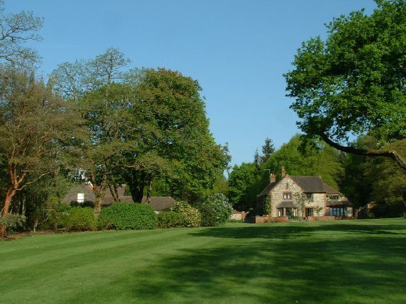 Twenty six acres of woodland garden with greenhouses, thatched folly, 2 ponds, sweeping lawns, large disused flint pit and many colourful plants.