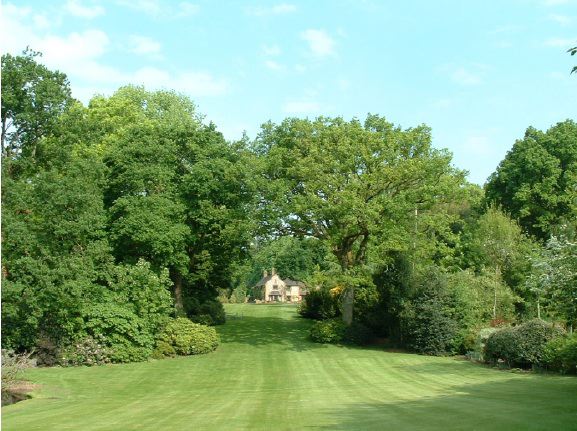 Twenty six acres of woodland garden with greenhouses, thatched folly, 2 ponds, sweeping lawns, large disused flint pit and many colourful plants.