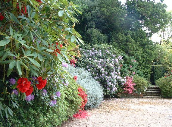 Twenty six acres of woodland garden with greenhouses, thatched folly, 2 ponds, sweeping lawns, large disused flint pit and many colourful plants.