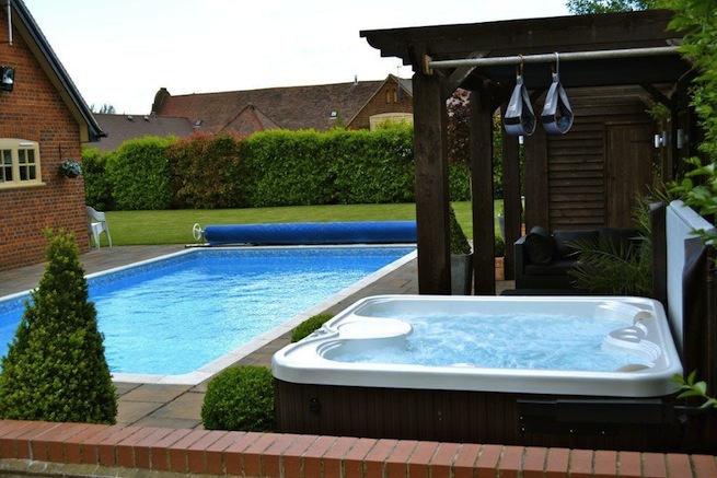 Family swimming pool with adjoining spa with a beautiful view of countryside.