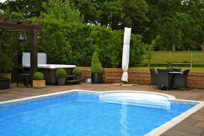 Family swimming pool with adjoining spa with a beautiful view of countryside.
