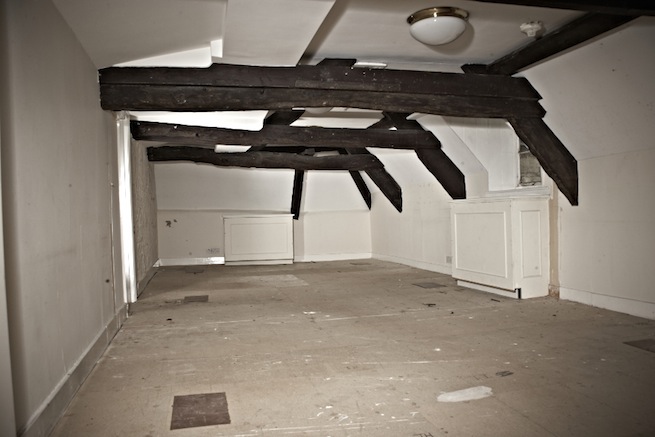 A large 17th century town house in the process of restoration. Some rooms have been done up, each with its own look and some rooms are empty.
