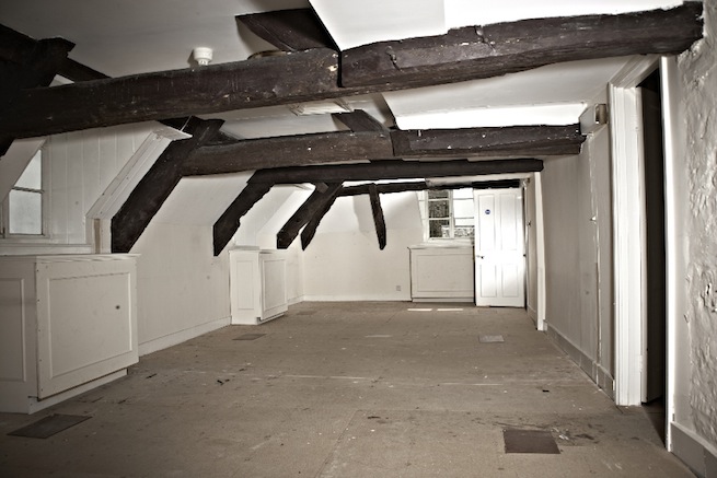 A large 17th century town house in the process of restoration. Some rooms have been done up, each with its own look and some rooms are empty.