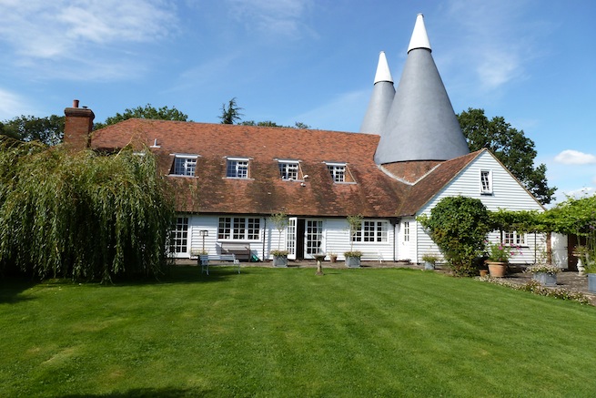Large converted twin kiln oast with attached converted barn and stables. Large rooms with beams, eclectic decor in old french farmhouse style. Large garden and paddocks.