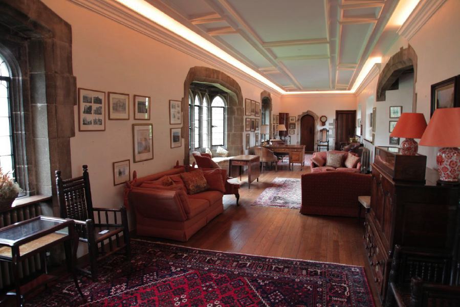 Sitting room with beautiful stone mullion windows in a historic house