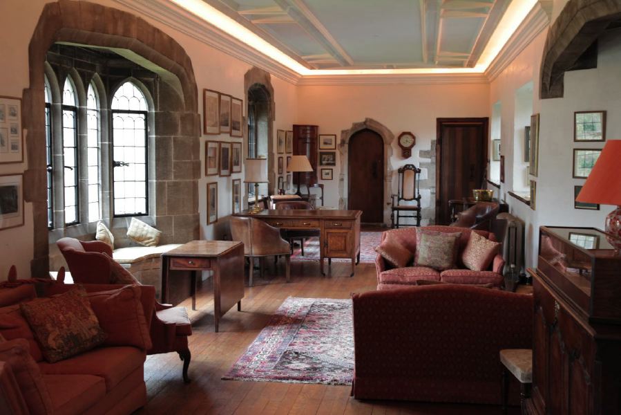 Sitting room with beautiful stone mullion windows in a historic house