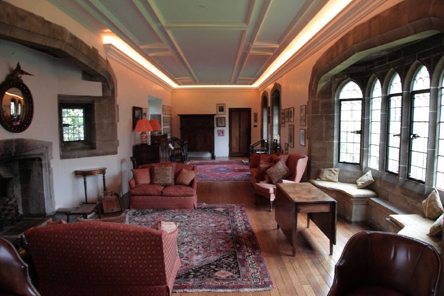 Sitting room with beautiful stone mullion windows in a historic house