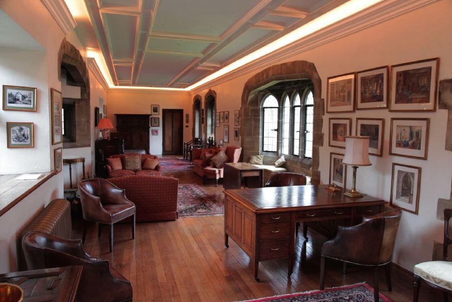 Sitting room with beautiful stone mullion windows in a historic house