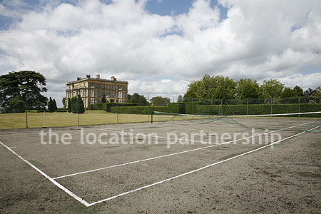 Private tennis court in the grounds of a country mansion.