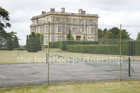 Private tennis court in the grounds of a country mansion.