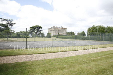 Private tennis court in the grounds of a country mansion.