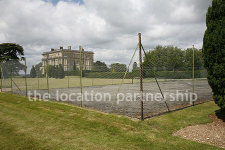 Private tennis court in the grounds of a country mansion.