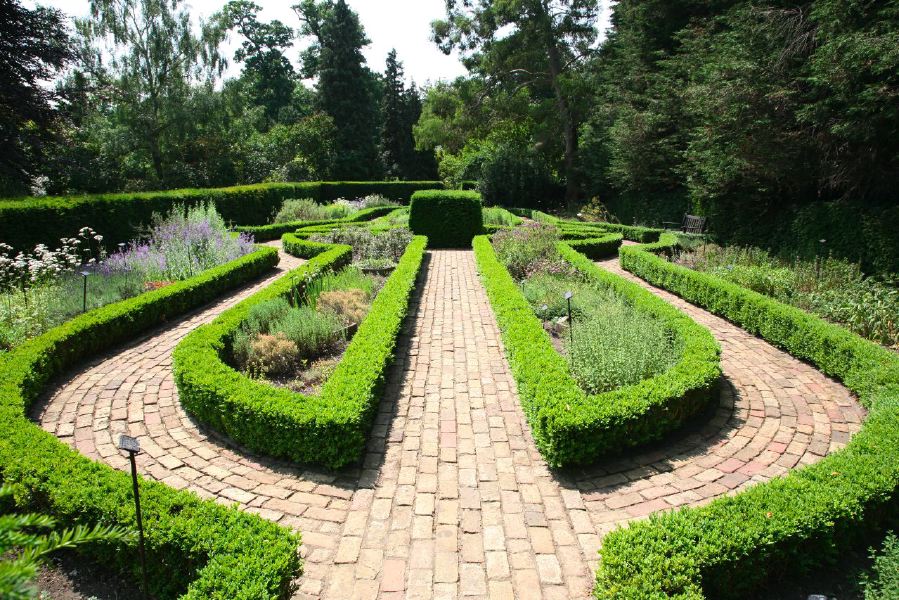 Topiary gardens, rose gardens, formal gardens and parkland around a Medieval Manor House