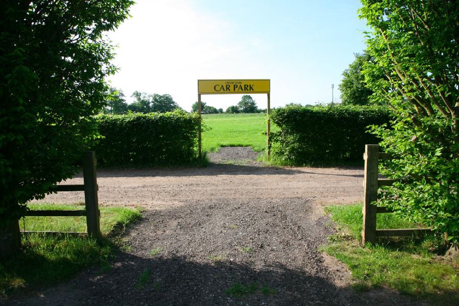Gravel tracks lined with trees and hedges