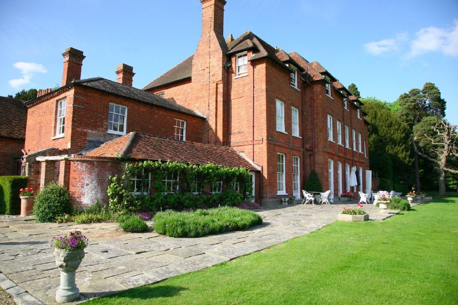 York stone patio along the front of a pretty country house