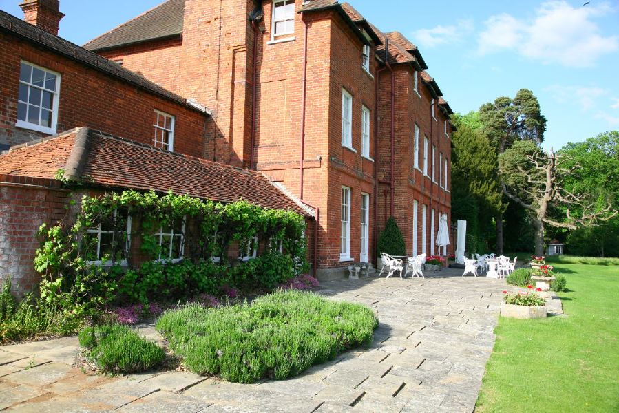 York stone patio along the front of a pretty country house