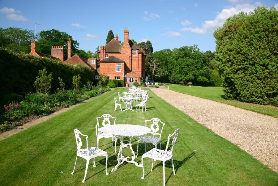 York stone patio along the front of a pretty country house