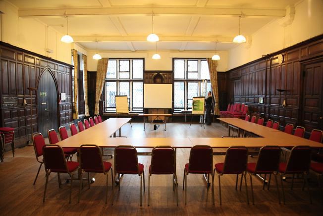 An elegant wood panelled room decorated in the arts and crafts style.