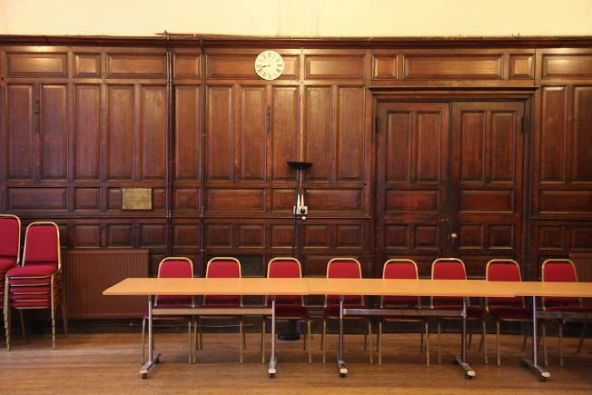 An elegant wood panelled room decorated in the arts and crafts style.