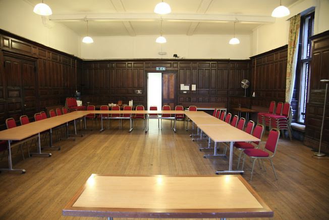 An elegant wood panelled room decorated in the arts and crafts style.