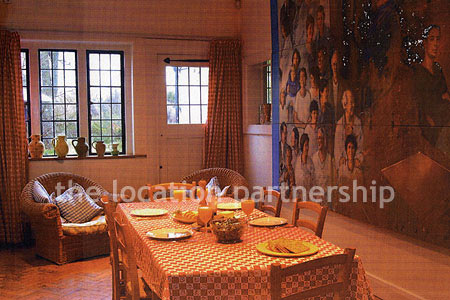 A very large country style house with three reception rooms, eight bedrooms and 1.2 acres of south facing garden
