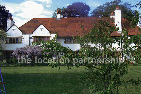 A very large country style house with three reception rooms, eight bedrooms and 1.2 acres of south facing garden