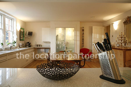 Spacious modern kitchen with island in large ground floor flat.