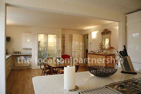 Spacious modern kitchen with island in large ground floor flat.