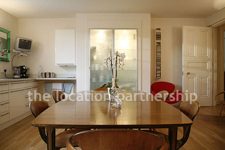 Spacious modern kitchen with island in large ground floor flat.
