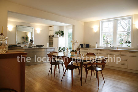 Spacious modern kitchen with island in large ground floor flat.