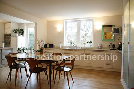Spacious modern kitchen with island in large ground floor flat.