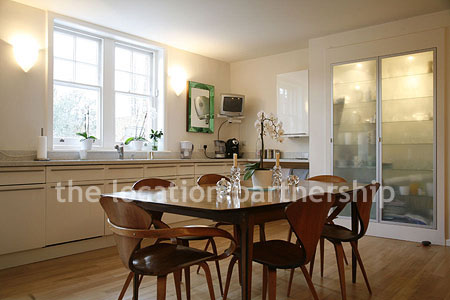 Spacious modern kitchen with island in large ground floor flat.