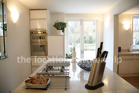 Spacious modern kitchen with island in large ground floor flat.