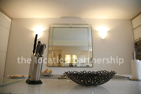 Spacious modern kitchen with island in large ground floor flat.