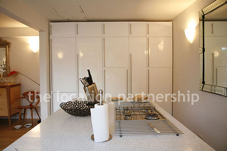 Spacious modern kitchen with island in large ground floor flat.