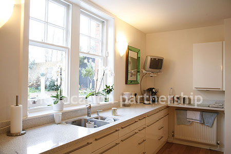 Spacious modern kitchen with island in large ground floor flat.