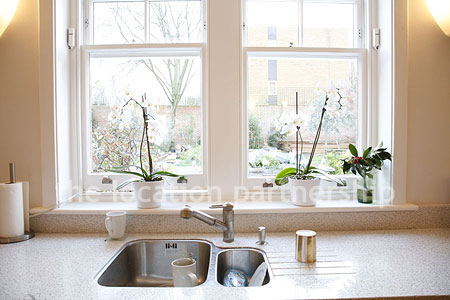 Spacious modern kitchen with island in large ground floor flat.